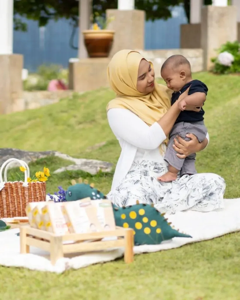 A Groomy parent and baby together outdoors